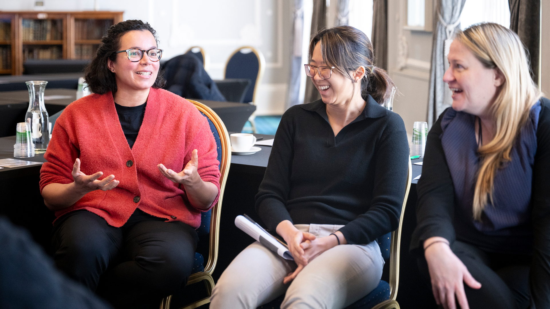 Group of participants interacting at a Training the Clinical Trainer Course